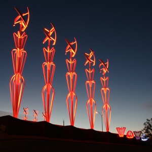 Illuminated sculptural art installation at dusk